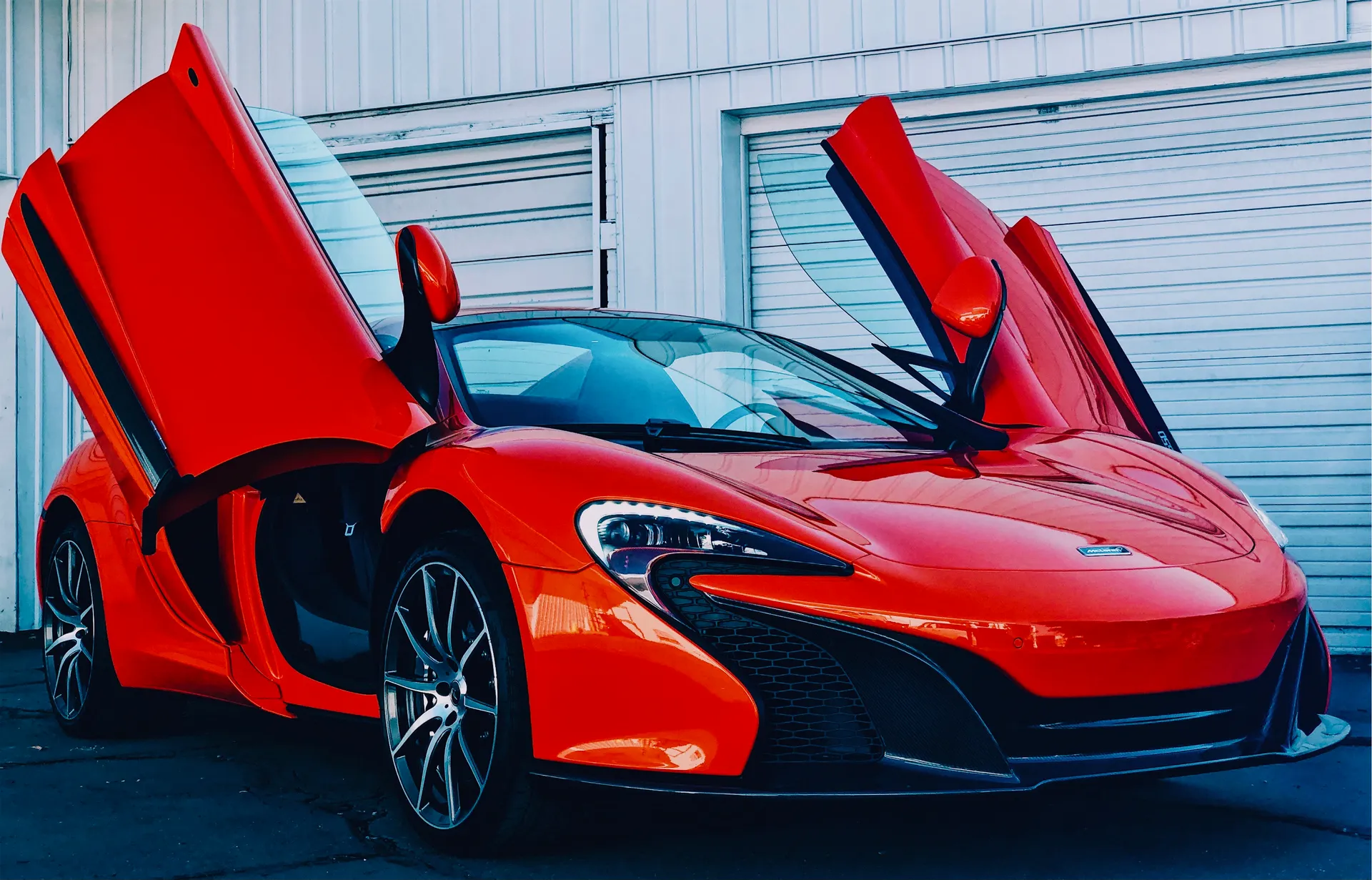 Red McLaren with doors up at 4s Custom